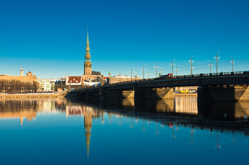 Fototapeta premium riga. in the photo, a panorama of the city and a stone bridge against the blue sky
