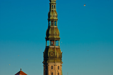 Fototapeta na wymiar the tower of St. Peter's church against the blue sky
