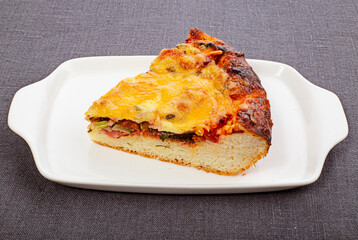 Meat pie with cheese crust and porcelain plate