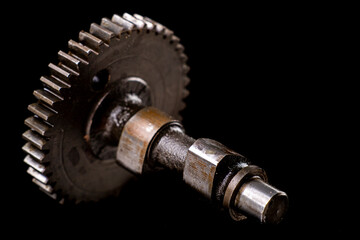 Camshaft from a small internal combustion engine. Accessories for repairing drive systems.