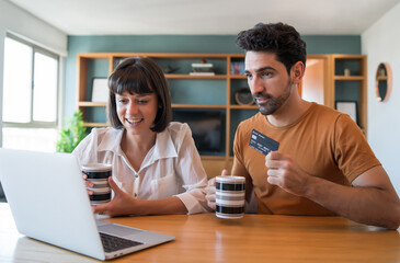 Young couple shopping online from home.