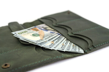 Close-up of an open female wallet with dollars inside.