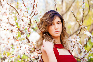 Portrait of a young blonde girl posing in spring park