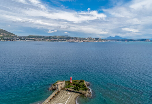 A view from Archaeological Museum of Campi Flegrei In the Castello Aragonese towards the sea, a lighthouse and the city of Naples, South Italy