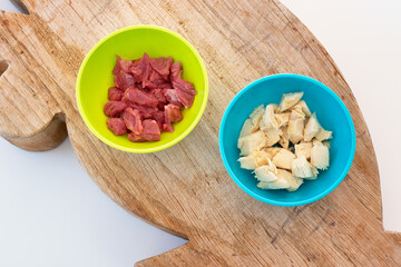 Cats nutrition concept. Different types of food for healthy feline. Comparison between raw beef, cooked chicken, canned meats and dry food. Wet or dry food? Natural or preserved food? Diet for cats.