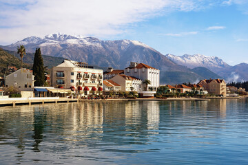 Fototapeta na wymiar Beautiful Mediterranean landscape on sunny winter day. Embankment of Tivat city. Montenegro, Adriatic Sea, Bay of Kotor