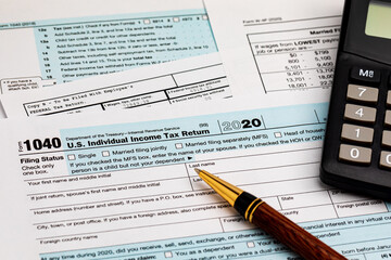 1040 individual income tax return forms and calculator. Concept of income taxes and federal tax information.
