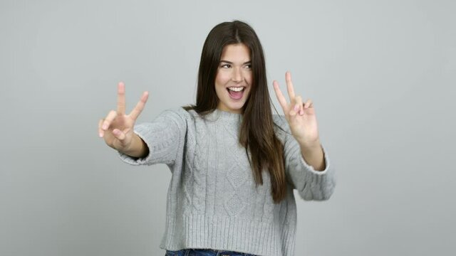 Teenager Brazilian girl smiling and showing victory sign with a cheerful face over isolated background