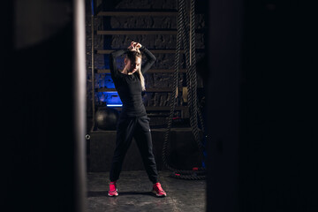 Young girl stands in an atmospheric gym. Sport