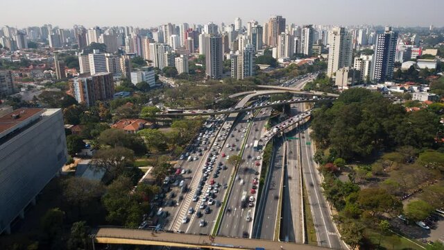 4K UHD Hyperlapse aerial drone footage of motorway 23 de maio in Sao Paulo, Brazil High view looking down on busy traffic at a junction in sunny day. Long exposure city life and transportation.