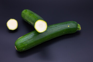 colorful bio fresh green zucchini on black background