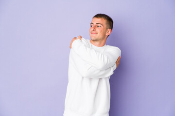 Young caucasian handsome man hugs, smiling carefree and happy.