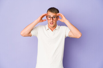 Fototapeta premium Young caucasian handsome man receiving a pleasant surprise, excited and raising hands.