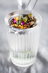 Herbal tea with chamomile, rose and mint close-up. Home remedy concept. Selective focus