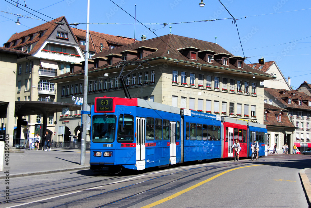 Wall mural tram in bern switzerland, public transport train red and blue