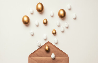 Easter golden Eggs in envelope on white background. Happy Holiday message, correspondence concept. Flat lay, minimal style greeting card