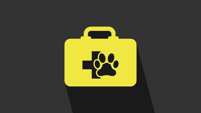 Yellow Pet first aid kit icon isolated on grey background. Dog or cat paw print. Clinic box. 4K Video motion graphic animation