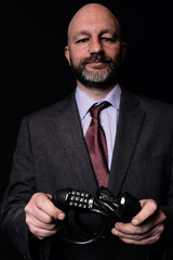 Business man in classic suit opening safe lock with numbers 2021. End of 2021 COVID 19 lockdown concept. Dark background. Selective focus. End of pandemic and isolation for business theme