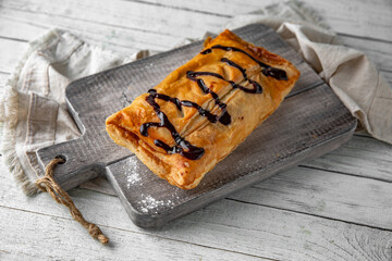 Puff pastry bun stuffed with apples, berries, or cottage cheese and potatoes, mini pie. Bakery products. Sweet pastry.