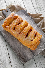 Puff pastry bun stuffed with apples, berries, or cottage cheese and potatoes, mini pie. Bakery products. Sweet pastry.