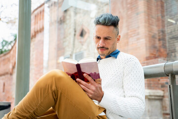 Businessman reading diary while sitting at bus stop