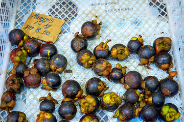 Half-empty box of mangosteen at a grocery store in Malaysia