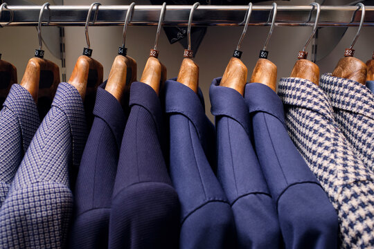 Row of blazers on rack in tailors boutique