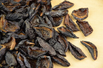 Prunes, dried plums fruits on wooden background, healthy fruits, closeup