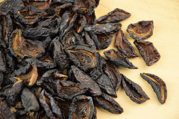 Prunes, dried plums fruits on wooden background, healthy fruits
