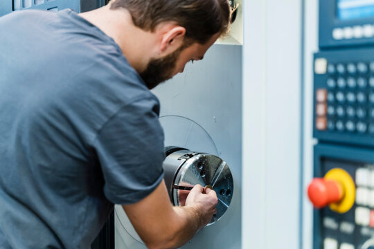 Maintenance worker operating machinery while working at factory