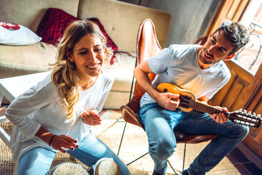 Sweet happy couple playing music