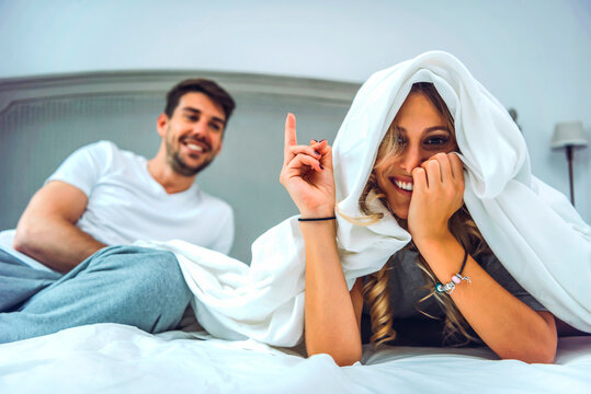 Joyful couple in bed