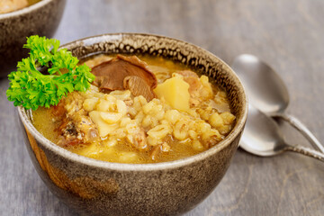 Homemade soup with mushroom and barley.