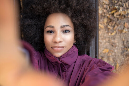 Afro young woman taking selfie