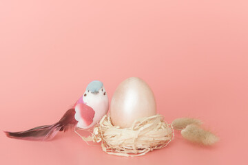 Easter eggs and a bird on a light pink background.