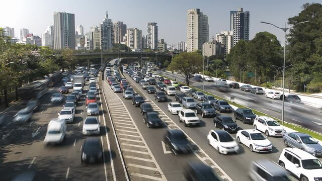  4K UHD Timelapse of car traffic at rush hour in S&atilde;o Paulo . Top view looking down at cars speeding by from walkway. Long exposure city life and transportation, concept background.