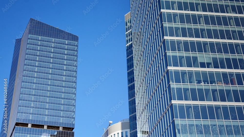 Wall mural glass facade of the buildings with a blue sky. skyscrapers in the business city center.. background 