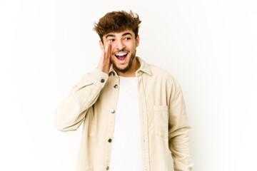 Young arab man on white background shouting excited to front.