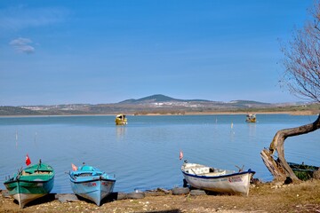 Gölyazı (Apolyont), Bursa Turkey. 22.01.2021. old and small fishing boats  with  uluabat lake background. 