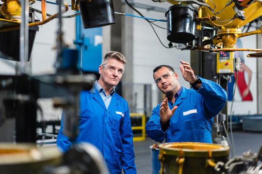 Technicians planning about machinery while working in industry