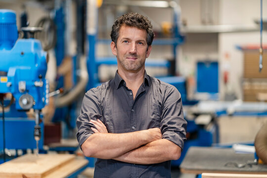 Portrait of carpenter posing with crossed arms