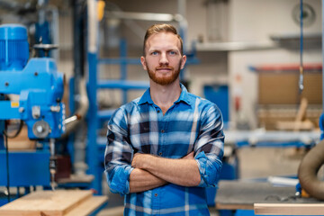 Portrait of carpenter posing with crossed arms