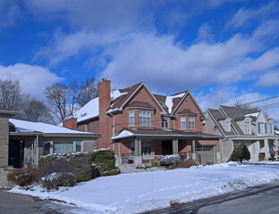 Suburban Residential neighborhood with single family houses with large front yards on a sunny day in winter