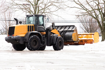 the yellow tractor removes the snow