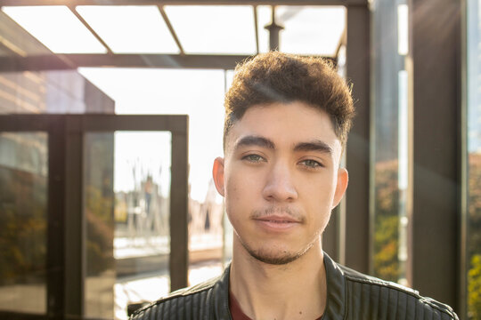 Young man with gray eyes in lobby on sunny day