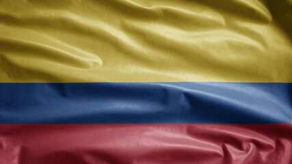 Colombian flag waving in the wind. Close up of Colombia banner blowing soft silk