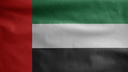 United Arab Emirates flag waving in the wind. Closeup of UAE banner blowing silk