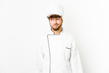 Young arab cook man confused, feels doubtful and unsure.