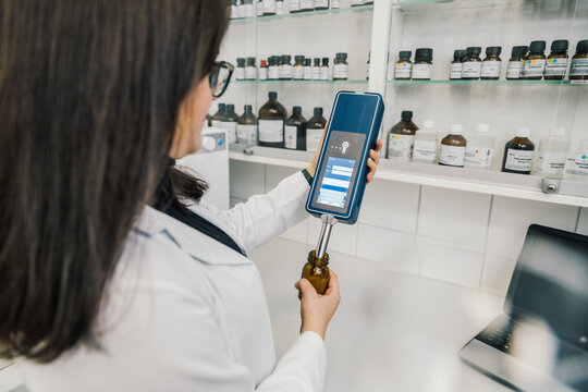 Pharmacist recommending medicine to smiling customer in chemist shop