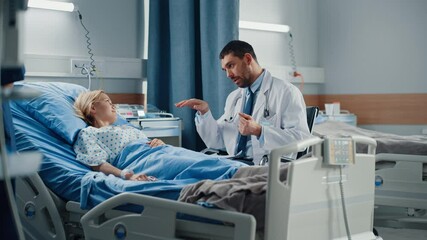 Hospital Ward: Friendly Doctor Talks to Smiling Young Woman Resting in Bed, Fully Recovering after Sickness. Physician Uses Tablet Computer, Does Checkup, Gives Treatment Advice, Health Recommendation